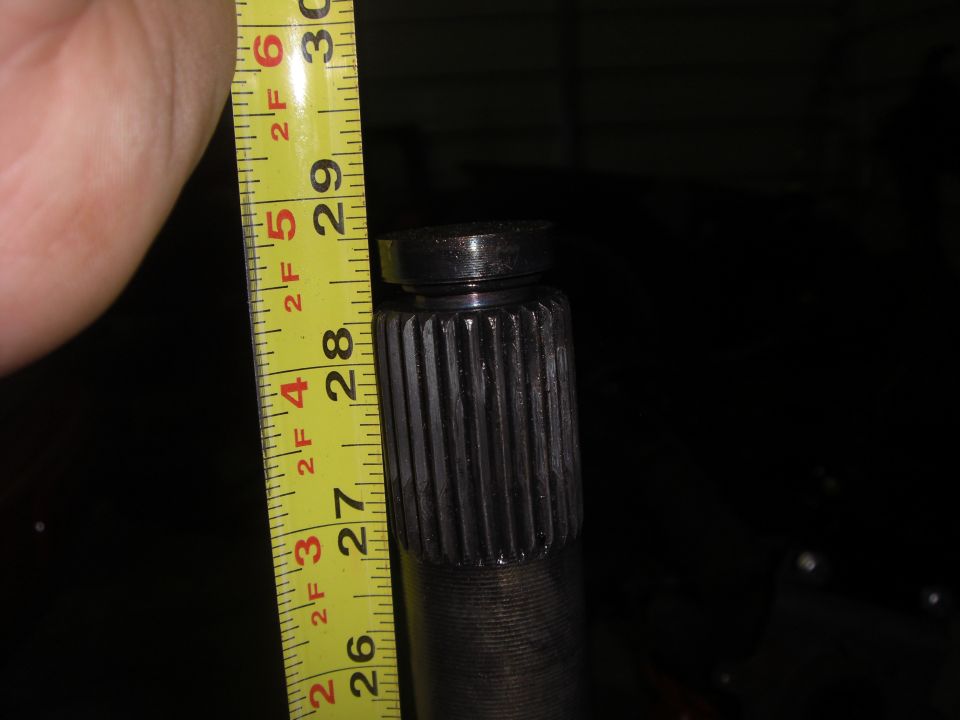 Splined shaft measured with a yellow tape measure showing approximately 28 inches