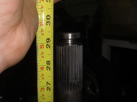 1988 Ford Bronco - A splined shaft is measured with a yellow tape measure, indicating a length of approximately 29 inches.