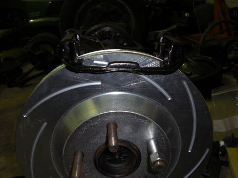 1988 Ford Bronco - Aftermarket slotted brake rotor and caliper assembly, likely for a Ford vehicle.