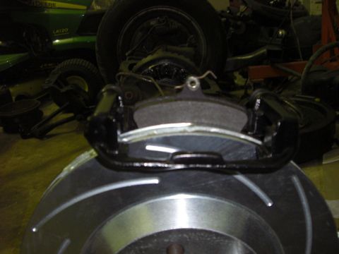 1988 Ford Bronco - A brake caliper and rotor are shown, with a John Deere tractor visible in the background.