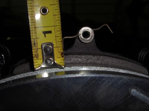 1988 Ford Bronco - A yellow steel tape measure is stood on edge against a dark cast component to check a dimension, with the hook resting on the machined surf…