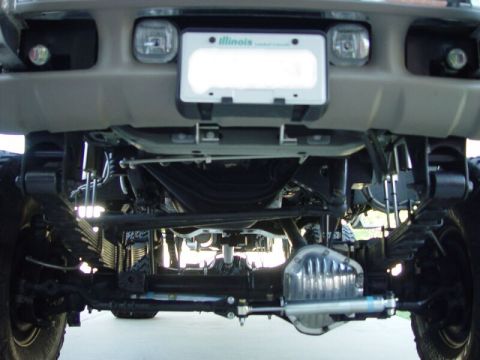 2001 Ford Excursion - The complex suspension and heavy-duty components are visible from this low-angle shot of the truck's undercarriage.