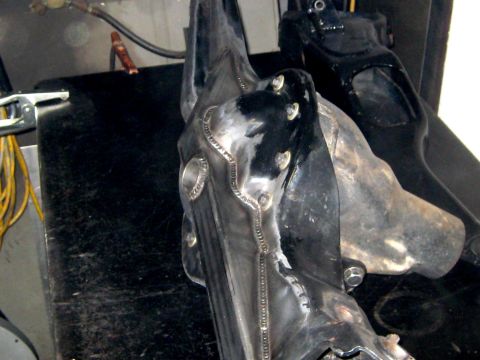 1996 Ford Bronco - Close-up of a fabricated metal part, likely for automotive use, showing extensive welding.