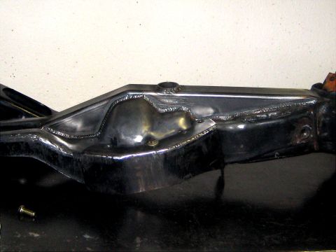 1996 Ford Bronco - A close-up view of a modified vehicle frame shows extensive welding work.