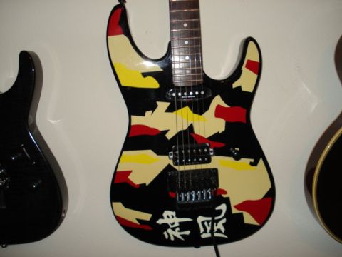 1979 Chevrolet C/K Pickup - Multiple electric guitars are displayed, one with a unique camouflage paint job and Japanese writing.
