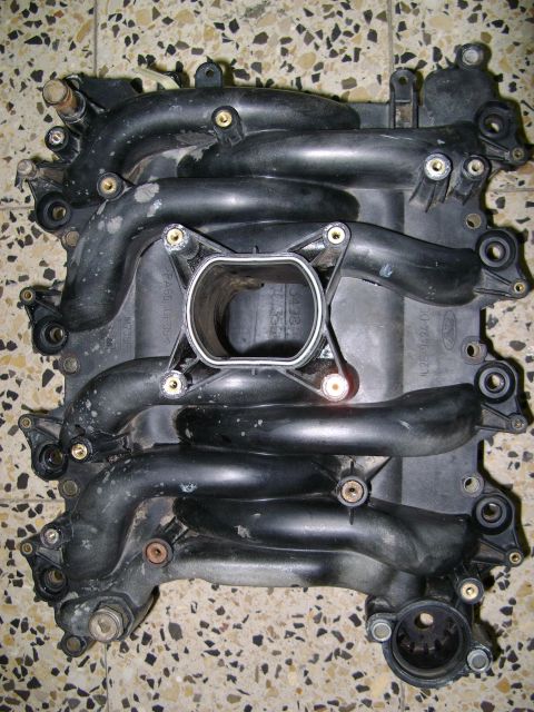 1998 Ford Crown Victoria - Plastic intake manifold with Ford logo visible, likely from a vehicle.