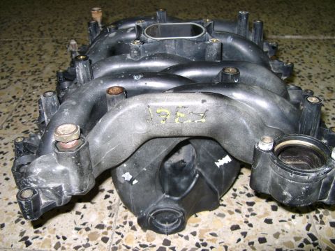 1998 Ford Crown Victoria - A plastic intake manifold is shown with yellow markings that appear to indicate the year 1997.