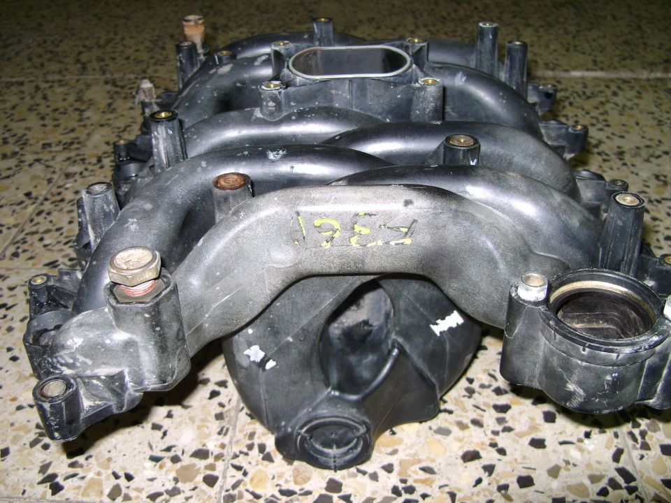 Plastic intake manifold with yellow markings '1997'