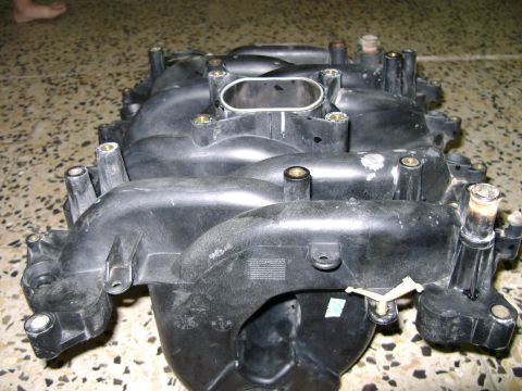 1998 Ford Crown Victoria - Plastic intake manifold shown from above, with visible ports and mounting hardware.