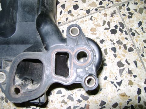1998 Ford Crown Victoria - This is a close-up view of a plastic intake manifold component, likely for an engine.