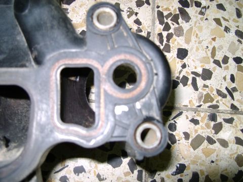 1998 Ford Crown Victoria - A close-up view of a plastic intake manifold part, showing its internal structure and mounting points.