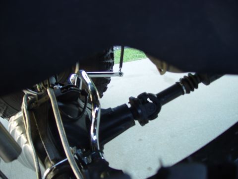 2001 Ford Excursion - Close-up view of the driveshaft and suspension system of a vehicle.