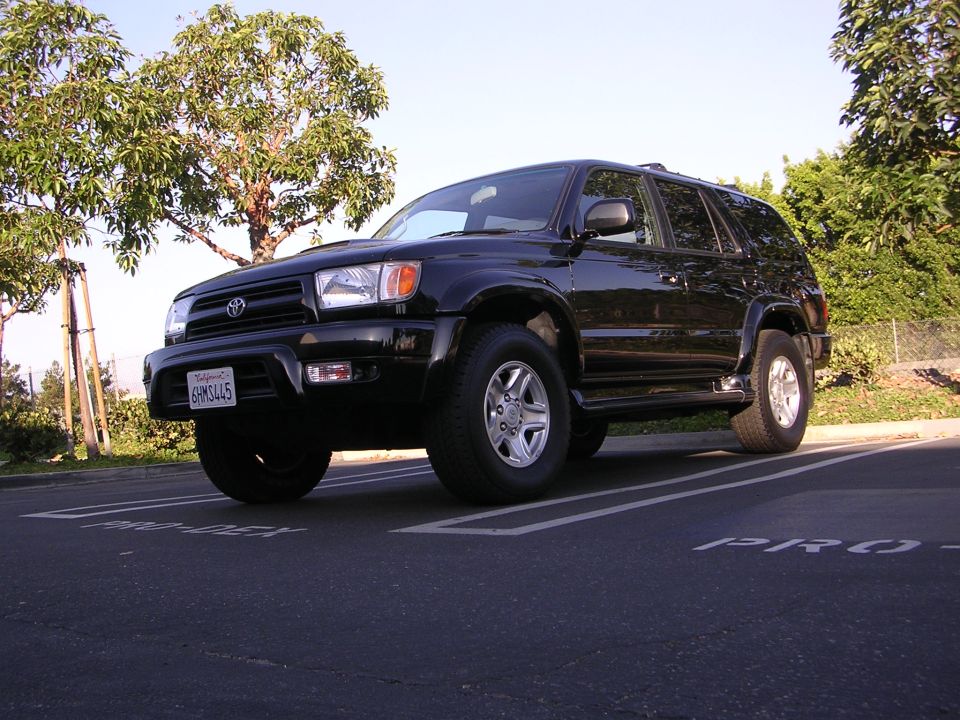 Black 2000 Toyota 4Runner parked in a lot, California license plate 6RM3445 visible