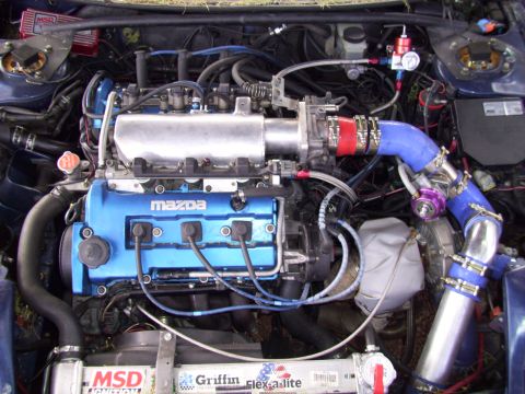 1995 Ford Probe - Customized engine bay a Mazda engine with turbo modifications and aftermarket parts.