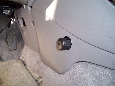 1995 Ford Probe - A close-up view of a knob and surrounding interior paneling in a vehicle.