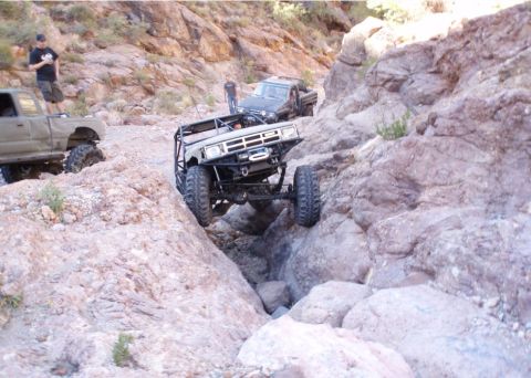1986 Toyota Hilux - Modified 1986 Toyota Hilux navigates a challenging rocky terrain with another truck visible in the background.