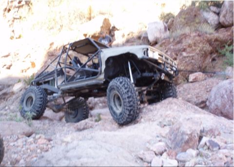 1986 Toyota Hilux - Modified 1986 Toyota Hilux buggy navigates rocky terrain.
