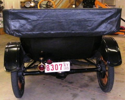 1915 Ford Model T - This 1915 Ford Model T is viewed from the rear, showing its black fabric top and a Kentucky license plate.