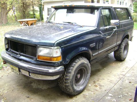 1994 Ford Bronco - This Ford Bronco appears to be from the early to mid-1990s, with a dark blue paint job and lifted suspension.