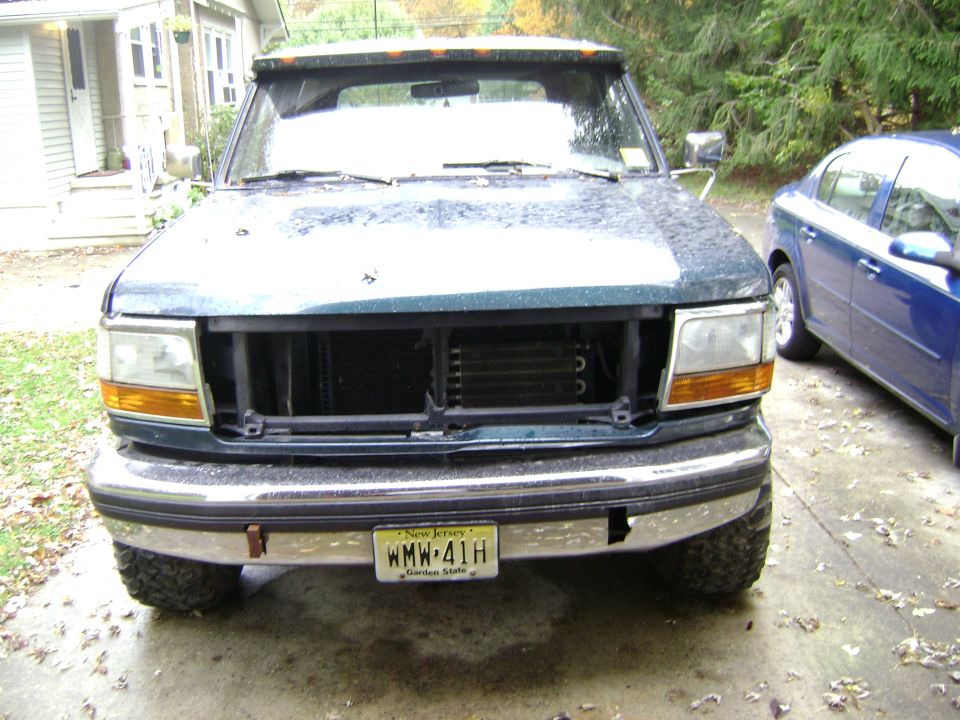 1994 Ford Bronco front view, dark green, missing grille