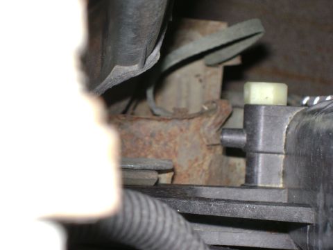 1994 Ford Bronco - A close-up view of engine components, showing rust and plastic parts.
