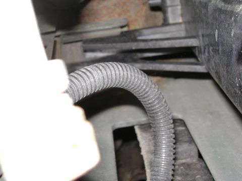 1994 Ford Bronco - A close-up view of a corrugated wire loom, likely part of a vehicle's electrical system.