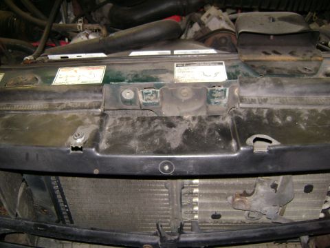 1994 Ford Bronco - The front of a vehicle's engine compartment is visible, with the radiator and various engine components.