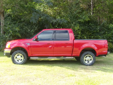 2007 Ford Mustang - This red Ford F-150 pickup truck is shown from the side, with the F-150 badge clearly visible on the fender.