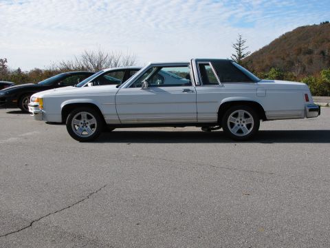 1985 Ford LTD Crown Victoria - Side profile of a white 1985 Ford Crown Victoria LTD parked outdoors.