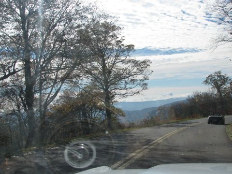 1985 Ford LTD Crown Victoria - A convertible drives along a scenic mountain highway during the fall.