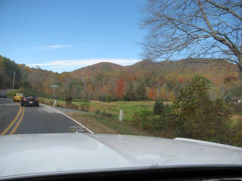 1985 Ford LTD Crown Victoria - Two convertible sports cars drive along a scenic road during the fall season.