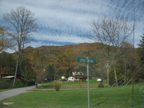 1985 Ford LTD Crown Victoria - A street sign reads "LITTLE CHESTNUT" in a rural area with houses and trees displaying autumn colors.
