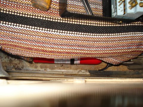 1967 Ford F-250 - A red fire extinguisher is visible beneath a seat cover, secured with a black strap.