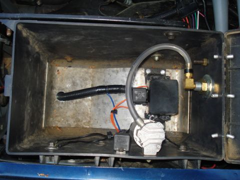 1984 Ford Bronco - Electrical components and a pump are visible inside a metal enclosure, with wiring and tubing connected.