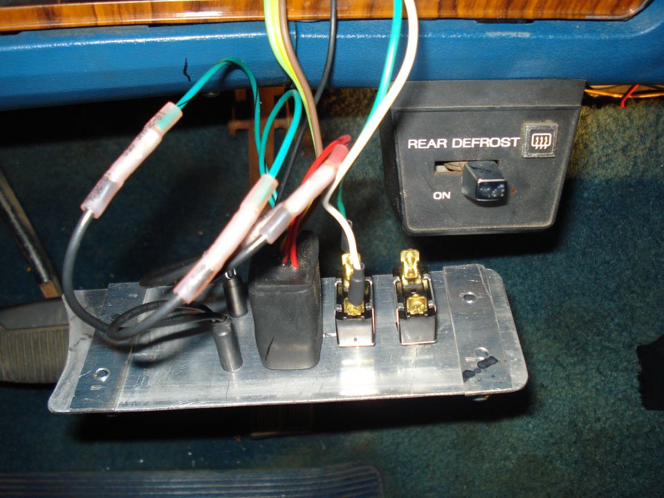 Custom aluminum under-dash switch panel wired with butt connectors beside rear defrost switch