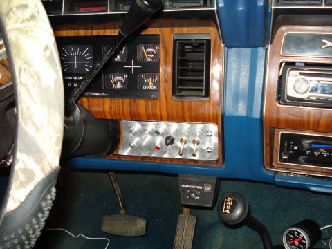 1984 Ford Bronco - Interior view of a 1984 Ford Bronco showing aftermarket switches and gauges on the dashboard.