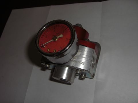 1988 Ford Bronco - A fuel pressure regulator with a red gauge is shown, with "MOTIVE" visible on its aluminum body.