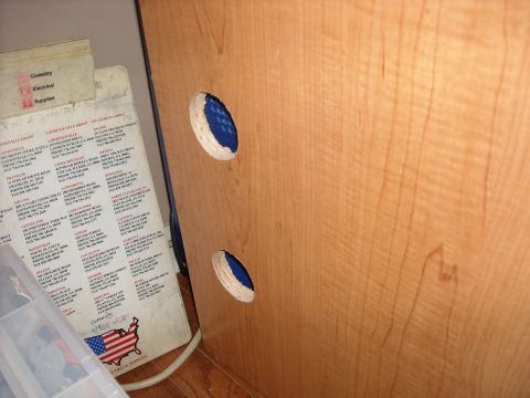 1979 Ford F-150 - A directory of electrical suppliers is shown next to a wooden surface with two circular openings revealing blue material.