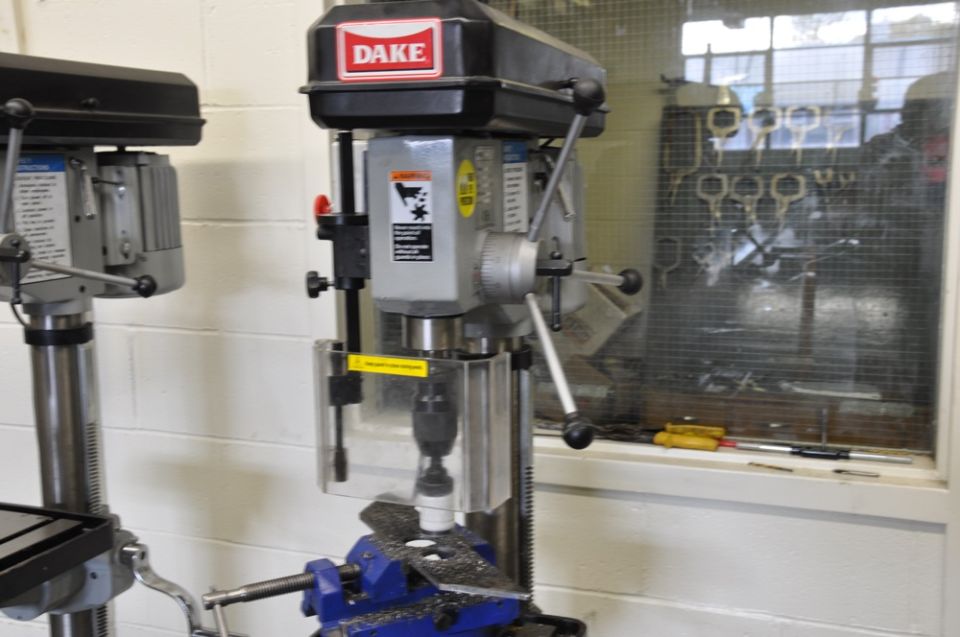 Dake drill press with blue vise and metal shavings