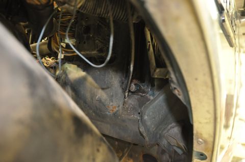 1996 Ford Bronco - This image shows a complex network of wires and metal parts within a vehicle's engine compartment.