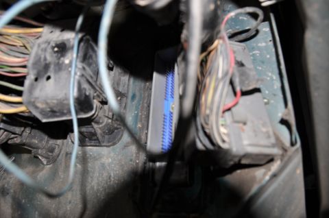 1996 Ford Bronco - Close-up view of a vehicle's engine computer wiring harness and connectors.