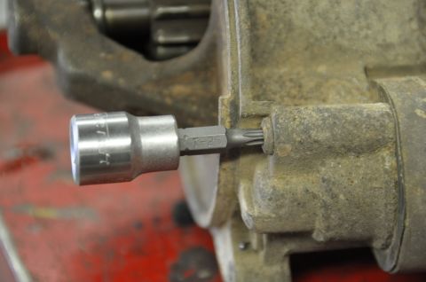 1996 Ford Bronco - A T-25 Torx bit is shown engaging a bolt on a starter solenoid.
