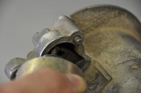 1996 Ford Bronco - Starter solenoid part shown in detail, with a finger interacting with its mechanism.