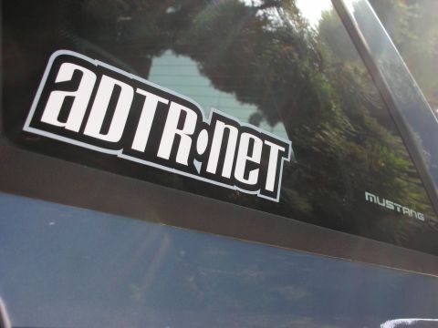 1990 Ford Mustang - A sticker reading ADTR.net is affixed to the rear window of a vehicle, with the 'Mustang' badge visible on the exterior.