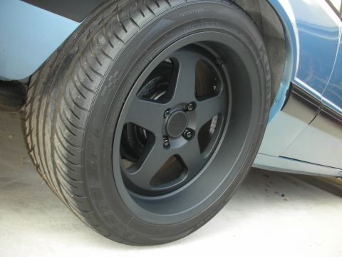 1990 Ford Mustang - Aftermarket wheel and tire detail on a blue vehicle.