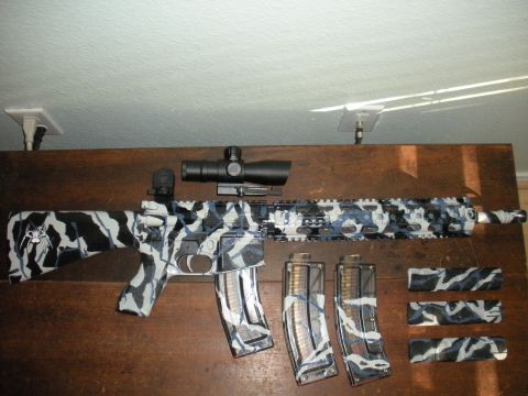 1996 Ford Bronco - An assault rifle with a distinctive camouflage pattern is displayed with its accessories.