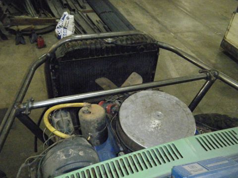 1978 Ford Bronco - The engine bay of a custom vehicle is visible, a roll cage and various engine components.