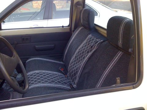 1989 Toyota Pickup/SR5 - View of the driver's side interior of a pickup truck, showing the seats and dashboard details.