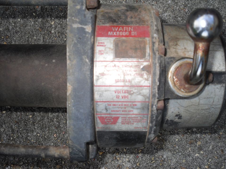 Warn MX8000 D1 winch with 12 VDC label and chrome handle