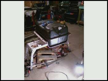 1996 Ford Bronco - Fuel tank on a stand in a workshop setting. No vehicle visible.